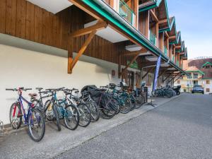 a row of bikes parked outside of a building at Résidence Vacancéole - Le Birdie in Giez