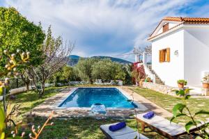 a pool in the backyard of a house at Μeropi & Natalia Villas in Skopelos Town
