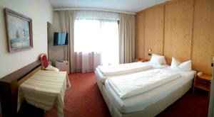 Postel nebo postele na pokoji v ubytování Hotel Rogen