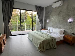a bedroom with a bed and a large window at DeerWood villa in Hinkong +27 photos