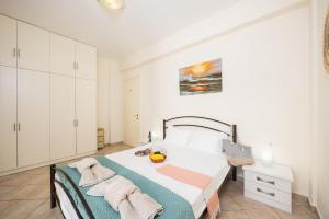 a bedroom with a bed in a white room at Villa Iremia in Astrakeri +38 photos