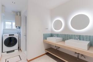 a bathroom with two sinks and a washing machine at Ubaku Villa 宇莫別荘 in Biei