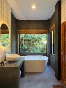 a large bathroom with a tub and a sink at DeerWood villa in Hinkong
