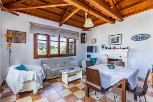 a living room with a table and a couch at Μeropi & Natalia Villas in Skopelos Town
