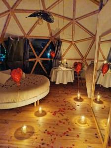 a room with a bed in a yurt with candles at Domaine des Pins L'île au Dôme 