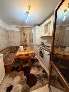a small kitchen with a table and a stove at Apartament in Craiova in Craiova