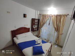 a bedroom with a bed and a window at Anyros Plaza in Mocoa