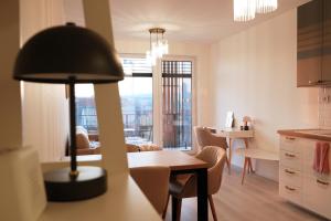 a kitchen and living room with a table and chairs at Homey 610 Apartment in Komárov