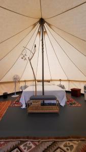 a bedroom with a tent with a bed in it at Glamping & country house Marche Nascoste Gualdo in San Girolamo di Sopra +18 photos