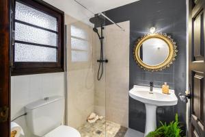 a bathroom with a sink and a toilet and a mirror at Casa Rural el Bac in Castellar de NʼHug +28 photos