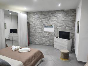 a bedroom with two beds and a television in it at Garibaldi guest house in Catania