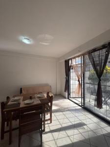 a dining room with a table and a couch at Apartamentos en la isla de Margarita in La Loma