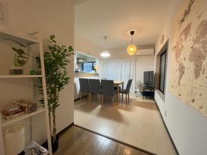 a living room and dining room with a table and chairs at koto KAWASAKI in Kawasaki