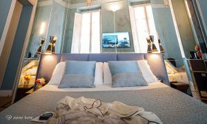 a bedroom with a bed with a blanket on it at Albergo Diffuso Birkin Castello in Cagliari