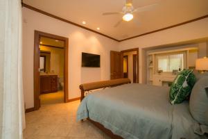 a bedroom with a bed and a bathroom at Veranda 8F - 2 bdr 2 bath - Condo in Isla Herradura