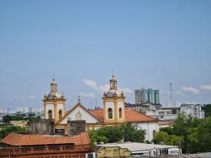 an old church with two towers in a city at Apartamento Centro Manaus 721 in Manaus