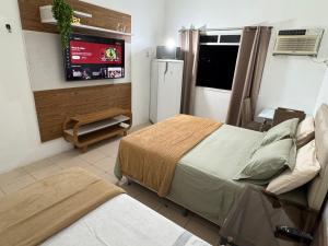 a hospital room with two beds and a television at Apartamento Centro Manaus 721 in Manaus +11 photos