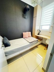 a small bed in a room with a window at Palmyra residence New condo in Kajang +3 photos