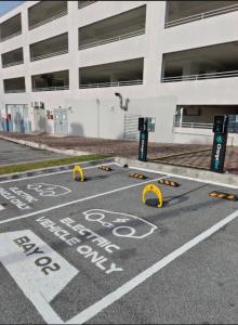 a parking lot with a no parking sign in front of a building at Palmyra residence New condo in Kajang