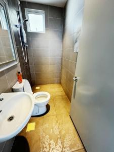 a bathroom with a toilet and a sink at Palmyra residence New condo in Kajang