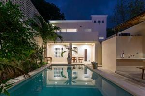 a house with a swimming pool at night at Chulel Hotel Origen in Cedro