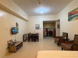 a room with a living room and a dining room at The Infinity Condominium BGC at high Street in Sampong