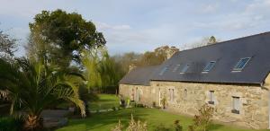 an old stone house with a black roof at Escapade Bretonne in Rospez +20 photos