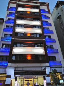 a tall building with blue lights on it at Napa Hotel in Denizli
