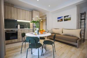 a living room with a couch and a table and chairs at Ammos Little Escape in Avdou