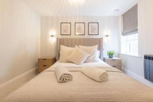 a bedroom with a large bed with two towels on it at Apartment 3 in York +26 photos