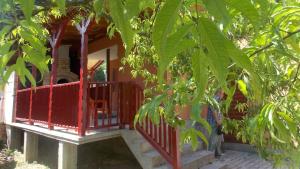 a porch of a house with a red railing at Villa ALVIK in Geoagiu Băi