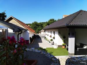 a courtyard of a house with a yard at Noszvaj Vendégház in Noszvaj