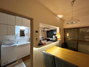 a kitchen with a dining table and a kitchen with at koto KAWASAKI in Kawasaki