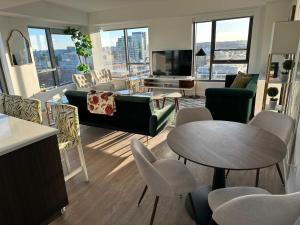 a living room with a couch and a table and chairs at Central Balance Life Work Play in Cambridge