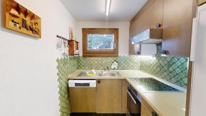 a small kitchen with a sink and a counter at Apartment Piz Argient in Samedan +4 photos