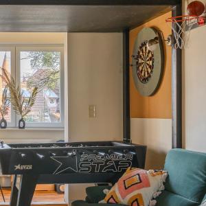a room with a ping pong table and a dart board at Boogas House - Gdańsk in Gdańsk