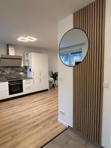 a kitchen and living room with a mirror on the wall at Modern apartment with feel-good factor in Grafenwöhr +2 photos