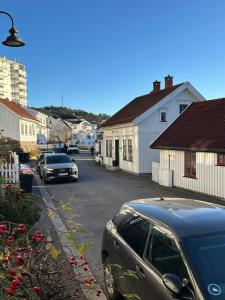 a street with cars parked in a residential neighbourhood at Anekset in Sandefjord