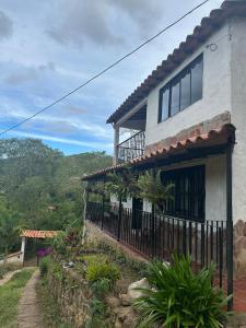 a house on a hill with a fence at Casa Campestre acogedora y con aventura al alcance in San Gil