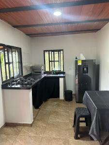 a kitchen with a stove and a counter top at Casa Campestre acogedora y con aventura al alcance in San Gil +2 photos