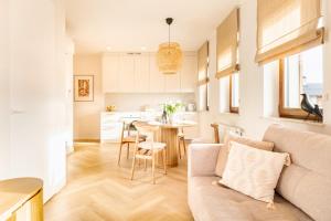 a living room with a couch and a table at Wino&Grono Nałęczów in Nałęczów