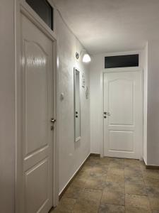 corridoio con porta bianca e pavimento piastrellato di Amy's Home a Craiova Altre 5 foto