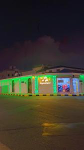 a building with green lights on the side of it at منتحع سيتي لاند 3 in Taif