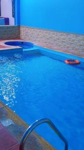 a red frisbee in a swimming pool with blue lights at منتحع سيتي لاند 3 in Taif