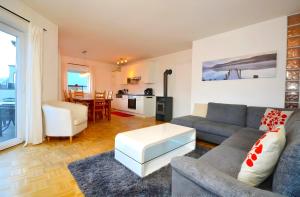 a living room with a couch and a table at Kitzsteinhorn Kaprun Panorama in Dürnberg
