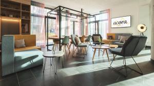 a lobby with chairs and tables in a store at Candlewood Suites Berlin Charlottenburg by IHG in Berlin