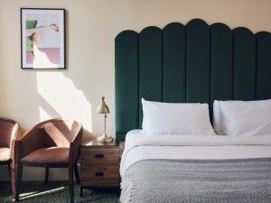 a bedroom with a bed and a green headboard at The Columbia in London +25 photos