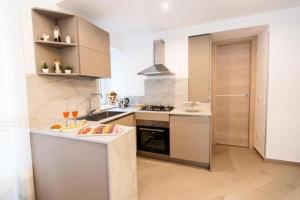 a kitchen with a counter with wine glasses on it at Casa Imperati in Agerola +11 photos