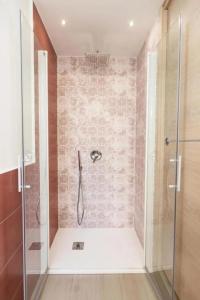 a bathroom with a shower with a glass door at Casa Imperati in Agerola