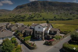 an aerial view of a house with a mountain in the background at Brantholme Bed & Breakfast in Ambleside